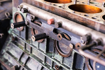 Mechanic repairs old motor of truck in a car repair station. Disassemble engine block vehicle. Motor capital repair. Car service concept