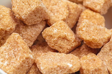 Brown cane sugar cubes isolated on white background
