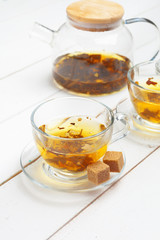 teapot and cups of tea on a white wooden background