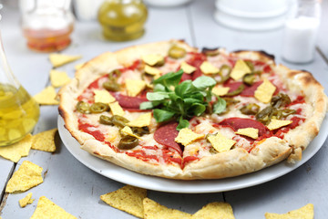 Fast food. Vegetarian pizza with crispy nachos.