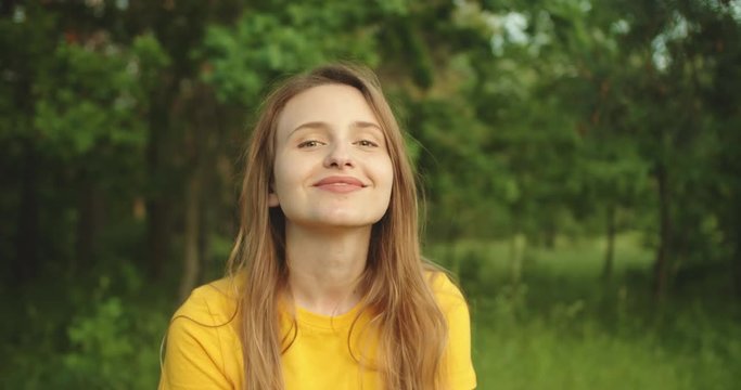 Beautiful girl smiling and  looking at the camera in the forest