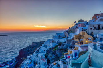 Fototapeta premium Oia village in Santorini island at sunset in Greece