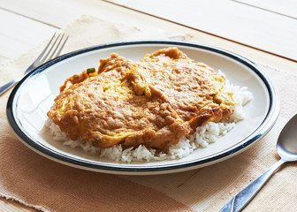 A plate of delicious Thai style pork omelette on top of rice