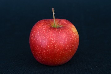 red apple on black background