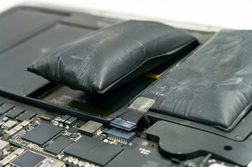 Lithium-ion battery on laptop, which has expanded.