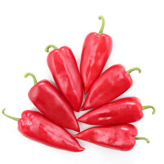 seven bright red sweet peppers on a white background. healthy fresh vegetables and food