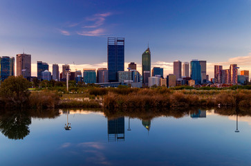 Fototapeta na wymiar Mirror Image Reflection in Pond at Sunset with Perth City in Background