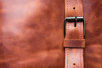 Closeup of a brown leather texture with a belt. Copy space
