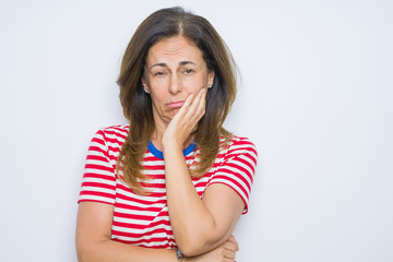 Middle age senior woman standing over white isolated background thinking looking tired and bored with depression problems with crossed arms.