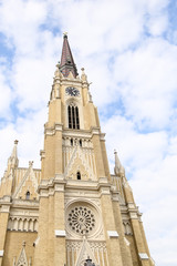 Fototapeta na wymiar The Name of Mary Church, Novi Sad catholic cathedral during a spring partly cloudy day.