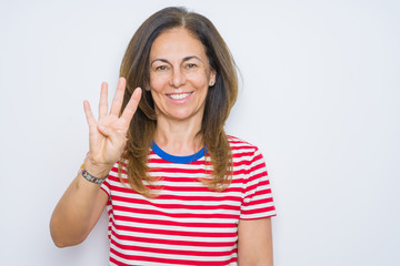 Obraz na płótnie Canvas Middle age senior woman standing over white isolated background showing and pointing up with fingers number four while smiling confident and happy.