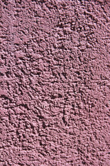 rough pink surface of old a wall with cracks and stains