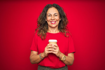 Middle age senior woman drinking a cup of coffee over red isolated background with a happy face...