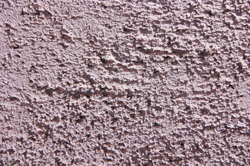 rough pink surface of old a wall with cracks and stains
