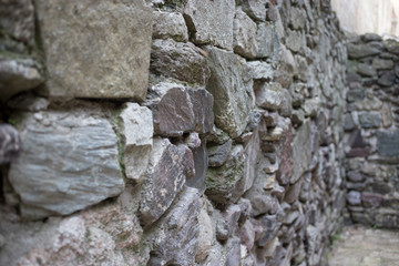 Close up of various shaped stone wall of medieval fortress.
