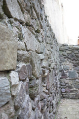 Close up of various shaped stone wall of medieval fortress.