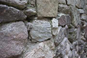 Close up of various shaped stone wall of medieval fortress.