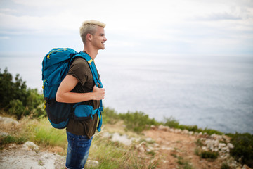 Traveler man with backpack landscape on background. Travel, happy, summer, vacations concept.