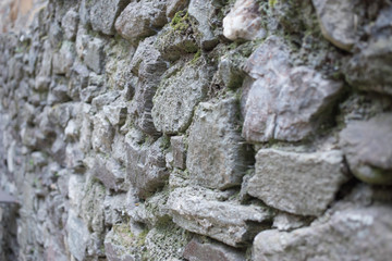 Close up of various shaped stone wall of medieval fortress.