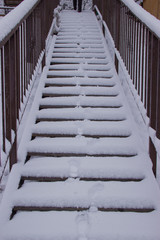 Fototapeta na wymiar Suddenly there was a big snowfall. Snow covered the stairs.