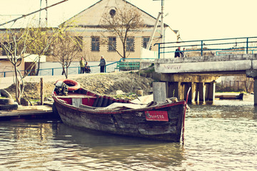 Danube river and fishing boat near the shore on a spring day.