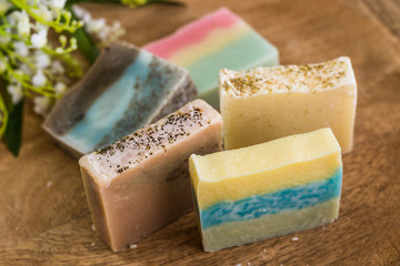 colorful handmade soaps on wooden background