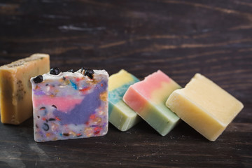 colorful handmade soaps on wooden background