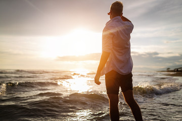 Young man enjoying sunset on summer vacation