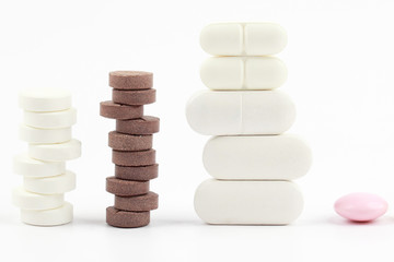different medicinal pills on white background
