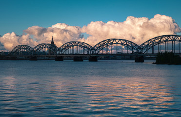 Fototapeta na wymiar dramatic clouds and railway bridge in Riga city