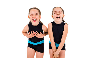 Portrait of identical twin girls dressed in rhythmic gymnastics dress.