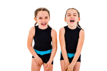 Portrait of identical twin girls dressed in rhythmic gymnastics dress.