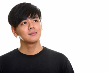 Studio shot of cool handsome Asian man thinking