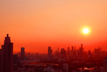 Marvelous sunset over the skyscrapers in vibrant red and orange color 