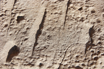 texture rough brown gray surface of an old cement wall with cracks, patterns and divorces