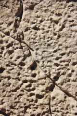 texture rough brown gray surface of an old cement wall with cracks, patterns and divorces