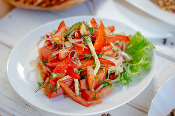 Achik-chukchuk salad made from fresh vegetables,on white plate.