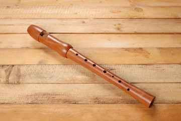 wooden flute rest on a wooden table with copy space for your text © Andrea