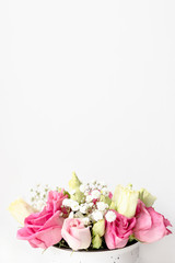 Fototapeta na wymiar Bouquet of eustoma and gypsophila flowers in front of white background with copy space