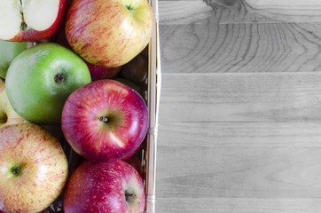 apples red and green in basket top view black white background