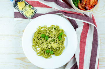 green spinach spaghetti with basil and cheese