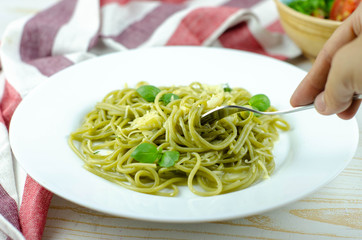 green spinach spaghetti with basil and cheese