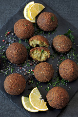 Falafel with spices on a stone board.
