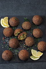 Falafel with spices on a stone board.