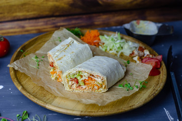 Homemade shawarma / burrito / chicken roll with vegetables and sauce. Top view ingredients