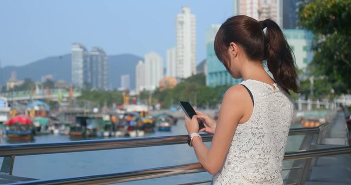 Woman use of mobile phone in the city