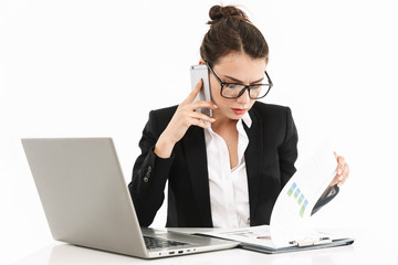 Photo of caucasian female worker businesswoman dressed in formal wear sitting at desk and working on laptop in office