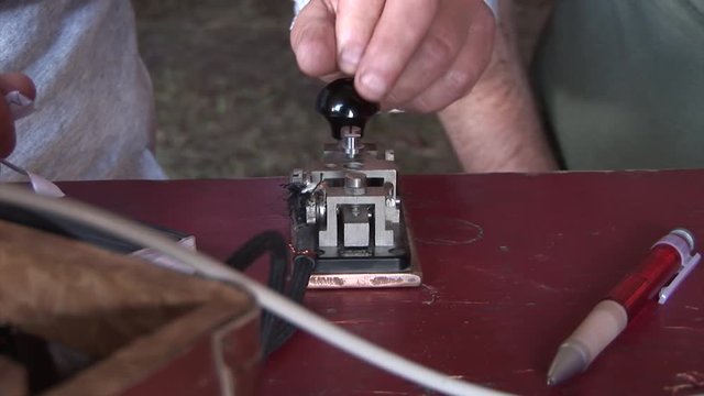 close up of hands man using Morse Code