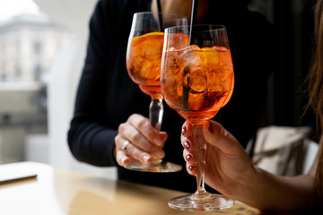 Making a celebratory toast with aperol spritz