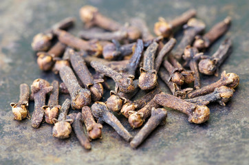 Organic spices, group of cloves, close-up on metal background